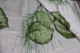 Two pieces of screen printed fabric, the cream ground having a large floral pattern in green and
