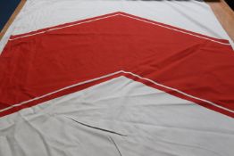 Two pieces of screen-printed cotton fabric, the pale green ground having a large red chevron design.