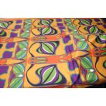 A piece of David Whitehead fabric, with orange ground and green, purple and orange abstract pattern,