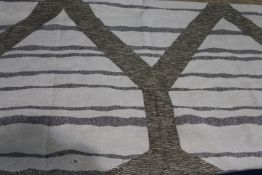 A piece of woven fabric with brown, beige and cream design, 115cm wide x 2m 50cm long
