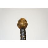Walking stick with four faced buddha handle