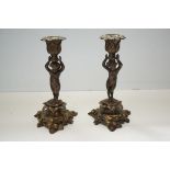 Pair of bronze cherub candle sticks