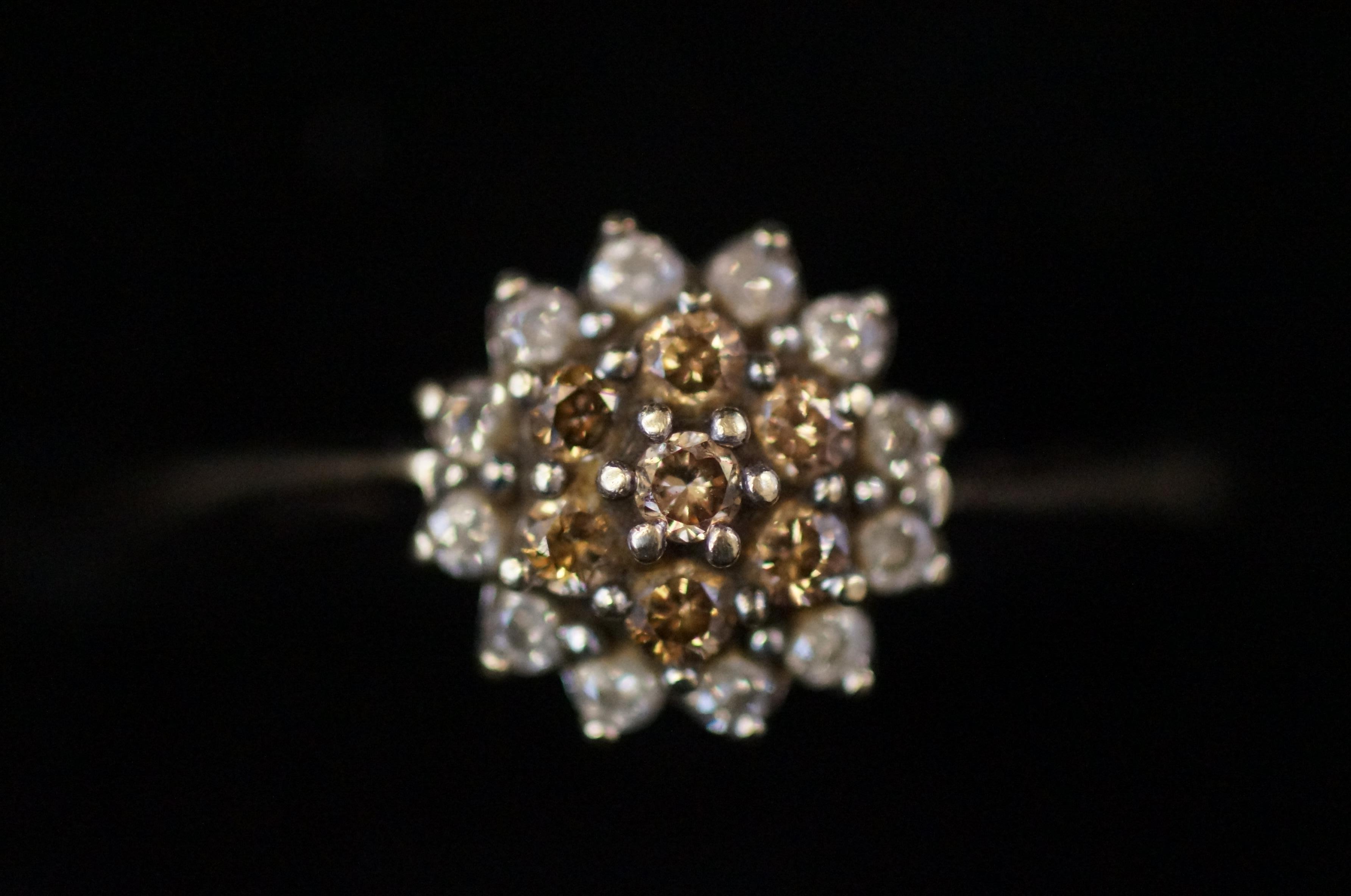 9ct Gold cluster ring set with white gem stones Si