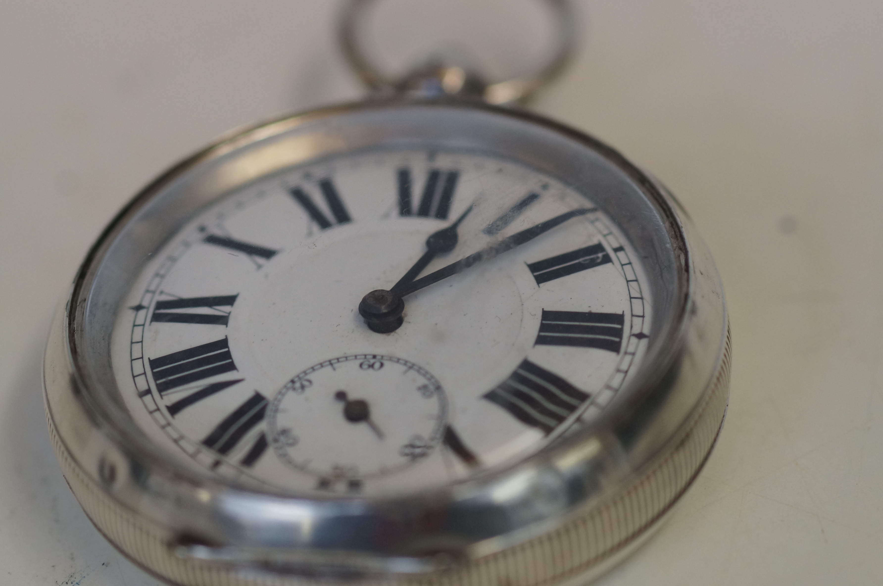 Silver pocket watch currently ticking