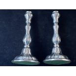 Pair of white metal candle sticks