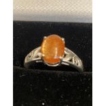 9ct White gold ring set with orange cabochon stone