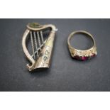 Early silver pin brooch in the form of a harp set