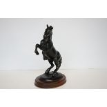 Ceramic figure of a black horse on wooden plinth - chip to ear