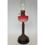Victorian oil lamp with enamelled floral design to