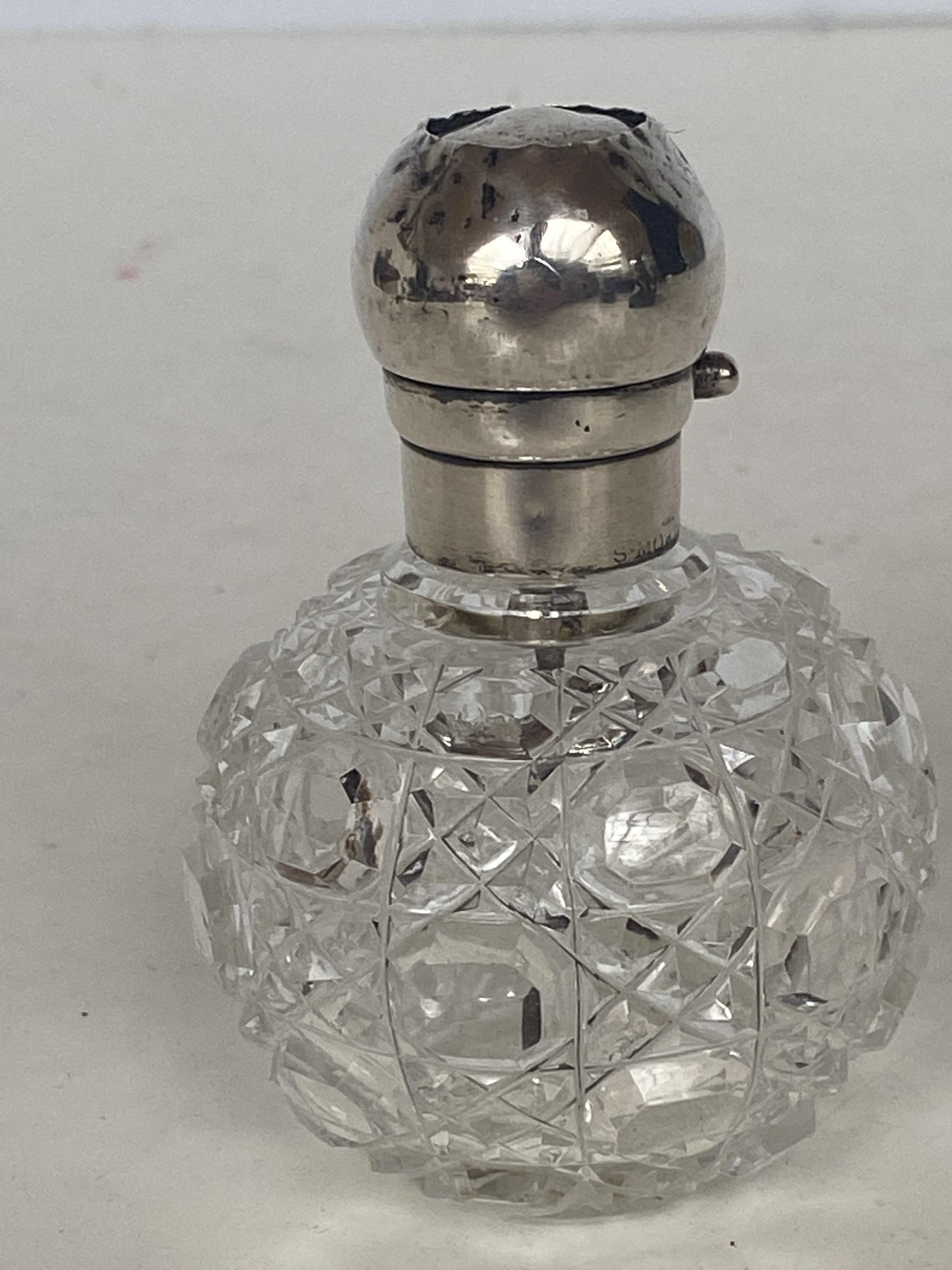 Silver top cut glass perfume bottle
