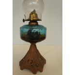 Early cast iron oil lamp with blue reservoir