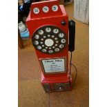 Red wooden cabinet in the style of a telephone