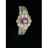 14ct gold ring set with 22 diamonds & central ruby