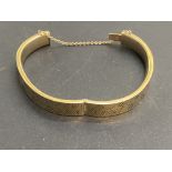 9ct gold bangle with safety chain. Total weight 16