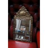 Ornate brass mirror