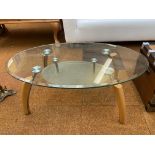 Modern glass coffee table with wooden legs
