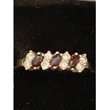 9ct gold ring set with red garnet's & cz stones We