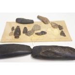 Collection of early arrow heads, flints & axe head