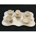 Miniature crested ware tea set on tray