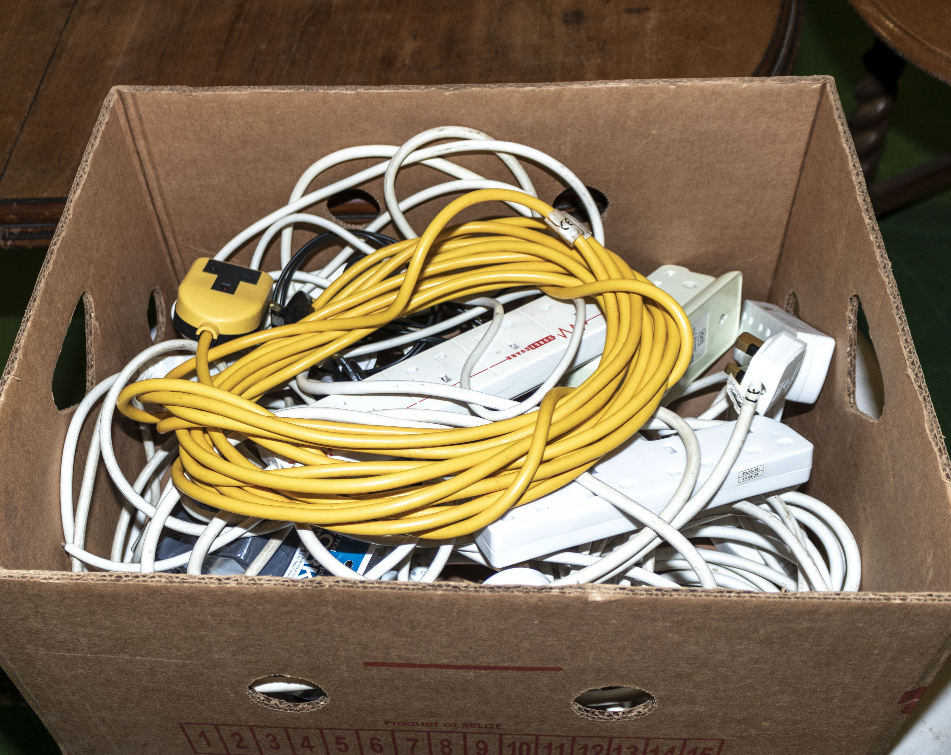 A box containing extension leads and adapters