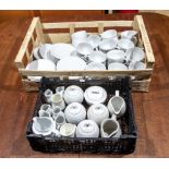 Two trays containing white cups and saucers, jugs and sugar bowls