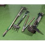 A bundle of garden tools, three spades, loppers, hoe, rakes and forks