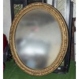 A gilt framed oval wall mirror