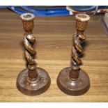 A pair of oak twist candlesticks