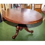 An oval mahogany dining table