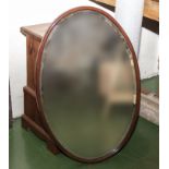 An oval wall mirror