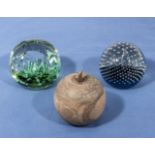 Two glass paper weights and a wood apple