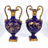 A pair of cobalt blue and gilt pottery vases, 42cm tall