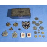 A collection of KOSB badges, coins and other items