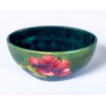 A small Moorcroft hibiscus pattern oval shaped bowl with Queen Mary label. A/F 16cm