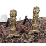 A pair of brass lion fire dogs