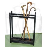 A stick stand and three walking sticks