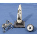 A horn thermometer, cigarette lighter and one other