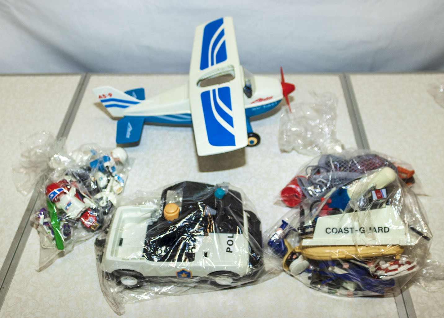 Vintage Playmobil aeroplane, police car, bundle of coastguard figures