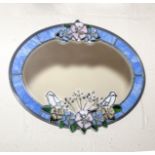 An oval framed wall mirror