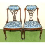 A pair of Edwardian upholstered mahogany bedroom chairs with cabriole legs