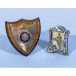 A small silver shield and a photograph frame