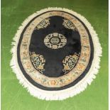 A black ground wool rug 190cm x 127cm
