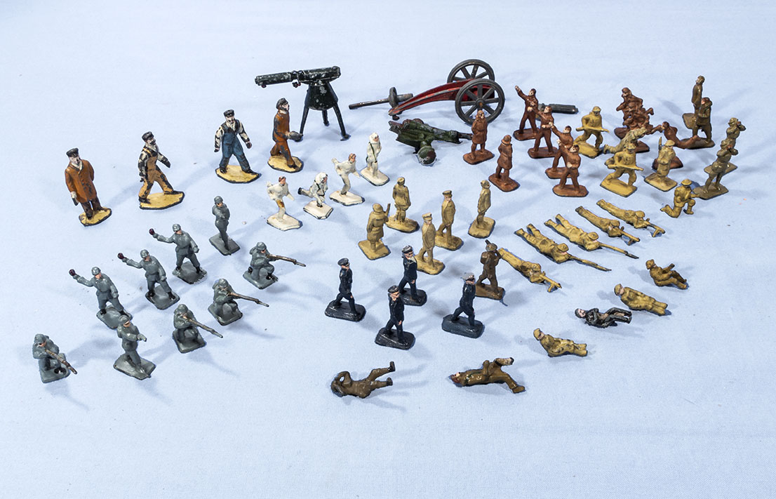 A collection of miniature lead soldiers and other items