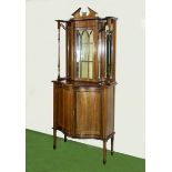 An Edwardian inlaid mahogany display cabinet on cupboards with serpentine front. 206cm tall 90cm