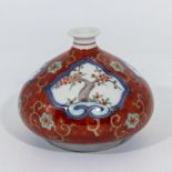 A small squat Chinese vase with decorative panels