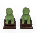 Two small Chinese green jade temple dogs and stands, 8cm without stands