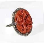 A white metal, marcasite and carved coral ring