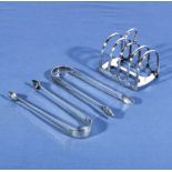 A small silver toast rack and two silver sugar tongs