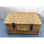 A small wicker picnic basket