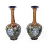 A pair of Doulton stoneware bottle shaped vases, initialled MB 26cm tall